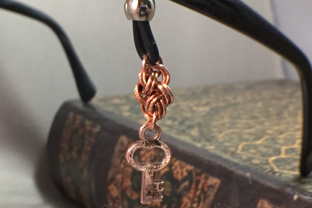 Four Winds chainmaille unit with key charms hanging on glasses