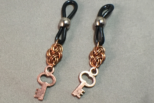 Chainmaille units and key charms hanging on eyeglass holders