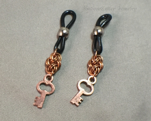 Chainmaille units and key charms hanging on eyeglass holders
